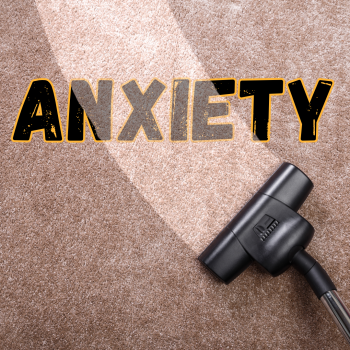 A vacuum cleaning a carpet with ANXIETY written across the carpet.