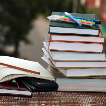 Stack of school books and pencils.